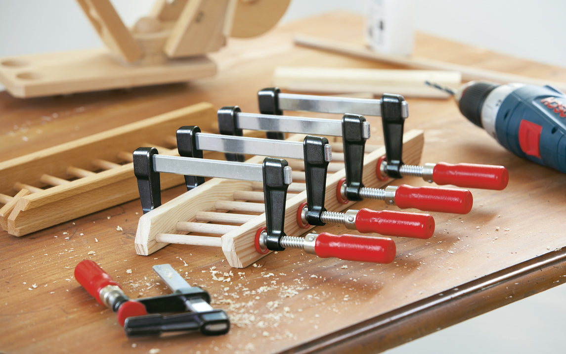 Bessey Clamps ~ Model No. LM2.008 - Light weight, & made of quality durable material, Bessey Light-Duty Steel Bar Clamps heads are made of tough die cast zinc, & black powder coated to prevent corrosion. Plastic pressure cap protect work piece surface. 330 lbs. Clamping force - Excellent for woodworking - 8" Long