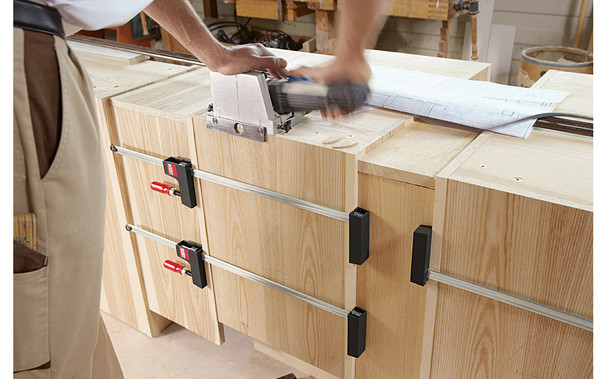 Bessey "UniKlamp" is a light duty universal clamp/spreader for bench top projects with a lighter frame & rail. Gentle touch jaws distribute the clamping pressure along the entire length of the rail & are ideal for sensitive work pieces & right angles. 12" max opening - 3-1/8" throat depth - Model UK3.012 - Wood handles - 091162006696