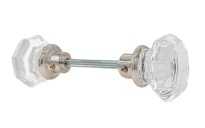 A high quality & genuine glass doorknob set with an attractive octagonal design. The sparkling center point under the glass amplifies reflected light to showcase beautiful facets. The rim of the brass base folds over the base of the glass knob for a secure grip. Polished Nickel Finish