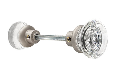 Pair of Classic Round Clear Glass Doorknobs with spindle. A high quality & genuine glass doorknob set with an attractive round design. The sparkling center point under glass amplifies reflected light to showcase beautiful facets. Solid brass base. Reproduction Glass Door Knobs. Traditional Round Glass Knobs. Brushed Nickel Finish.