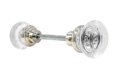 Pair of Classic Round Clear Glass Doorknobs with spindle. A high quality & genuine glass doorknob set with an attractive round design. The sparkling center point under glass amplifies reflected light to showcase beautiful facets. Solid brass base. Reproduction Glass Door Knobs. Traditional Round Glass Knobs. Polished Nickel Finish.