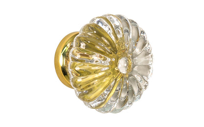 "Colonial Revival" Style Ribbed Glass Cabinet Knob with Unlacquered Brass Base. Made of genuine glass. The ribbed clear glass is carefully set into a handsome brass material base with a threaded shank. Non-lacquered brass (the un-lacquered brass will patina over time). Available in 1-3/4" diameter knob.