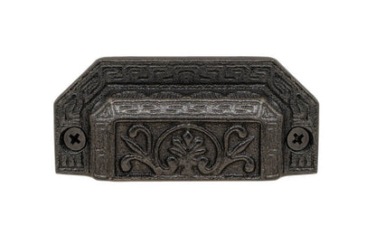 Rustic-looking & ornate cast iron bin pull with a very nice & charming ornate detail. Made of cast iron material, the bin pull is thick with a good grip. This Victorian style bin pull is originally from 19th century time period. Vintage finish with lacquer to resist rust. Cast Iron Ornate-Style Bin Pull ~ 3" on Centers