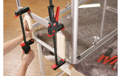 Bessey 12" DuoKlamp Clamp ~ DUO30-8 - One handed clamp & spreader. Clamp or spread with the turn of a button, no tools necessary. 12" max opening & 3-1/4" deep throat. Jaws resist flex & withstand up to 260 lb. of clamping force. Soft pressure caps prevent marring of wood by distributing pressure over a greater area.  