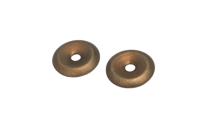 A stamped brass 7/8" diameter backplate with a small cup in the center. These finishing washers serve as back plates for knobs, bail sets etc. Sold as one pair.