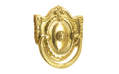 Vintage-style Traditional Hardware · Stamped brass drop pull in the Colonial Revival style. Made of stamped brass material with a nice detailed design of a "flower" at its center. Timeline: Early 20th Century, Colonial Revival, Depression Era, Waterfall style. Unlacquered brass. Non-lacquered brass
