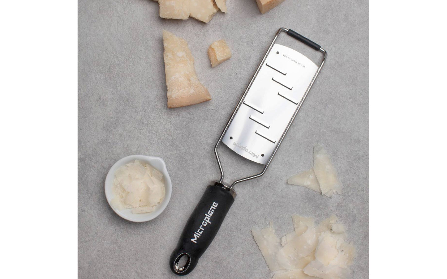 Made in USA - Blade made in USA - Great for shaving hard cheese, cucumber, chocolate, garlic, ginger - Non-slip grip - Dishwasher safe - Razor-sharp blades made from stainless steel - 18/8 grade - Ergonomic handle ~ No-slip base - Microplane Gourmet Series - Gourmet Shaver Grater - Model 45006 - Microplane Large Shaver - 098399450063