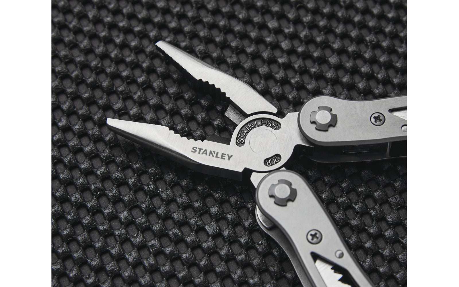 Stanley 12-in-1 Multi-Tool has stainless-steel construction with nylon holster. Includes long nose pliers, curve jaw pliers, wire cutter, saw, Phillips screwdriver, standard 1/4", 5/16", 1/8" screwdrivers, file, small knife, large knife, can opener, & bottle opener. Multi-purpose tool for everyday use. Model No. 84-519