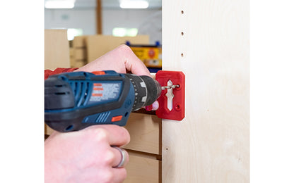The FastCap Hinge Jig locates the centerline for a hinge. It mounts easily into the 5mm holes & using the cursor to draw a centerline. If cabinets don’t have a 5mm holes, use pins & align them along the edge of the cabinet, drill with 5mm driver bit in the drill guides. For Euro style cabinets & finding hinge's center