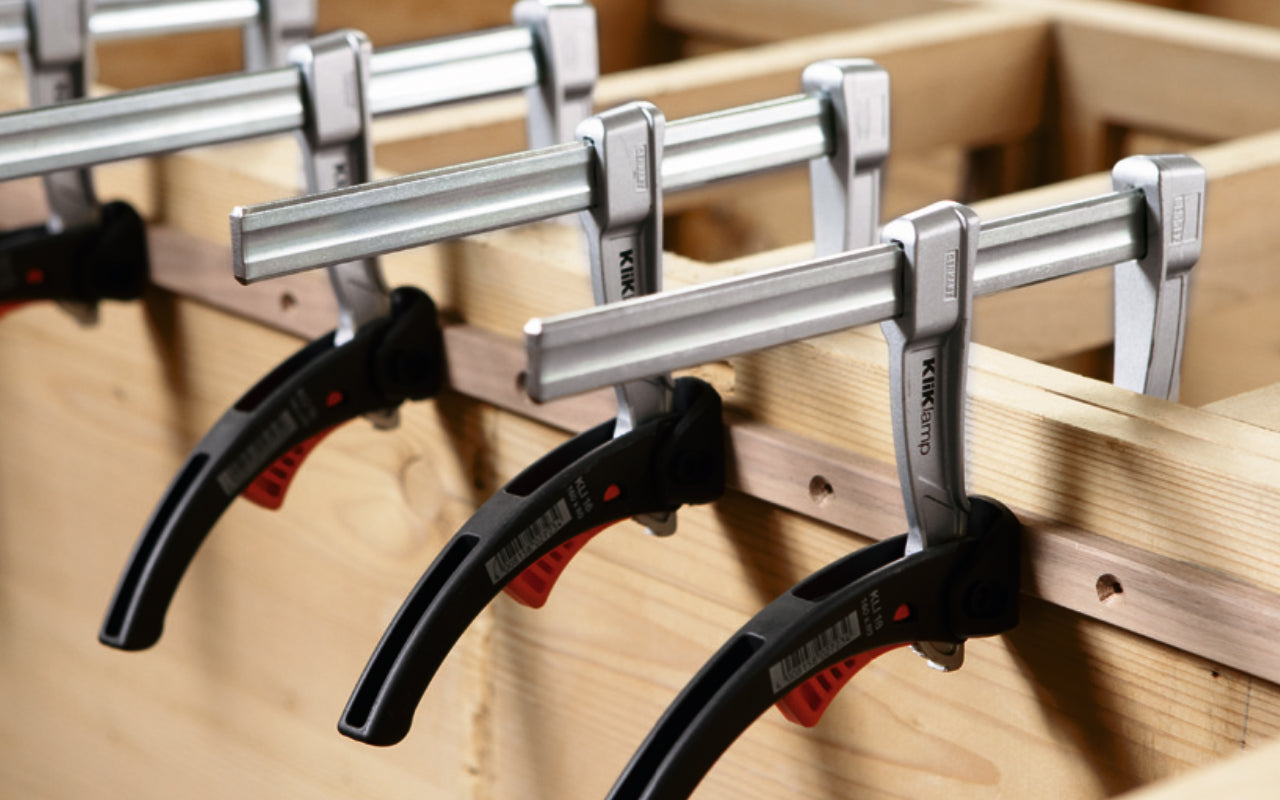 Bessey 12" KliKlamp Light Duty Lever Clamp KLI3.012 creates up to 260 lbs. of clamping force. Positive locking ratchet action. Made of sturdy magnesium which makes it lightweight & strong. Fixed arm with v-grooves holds round & angular components firmly in place. 12" clamping capacity - 3" throat depth. Made in Germany