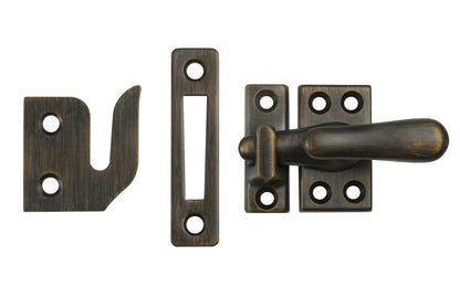 Classic & Traditional Solid Brass Casement Window Latch ~ Regular Size. 1-9/16" high x 7/8" wide latch turn base. Locks & tightens window frames or small doors. Reversible for right or left applications. Vintage-style casement window lock. Dark Antique Brass Finish.