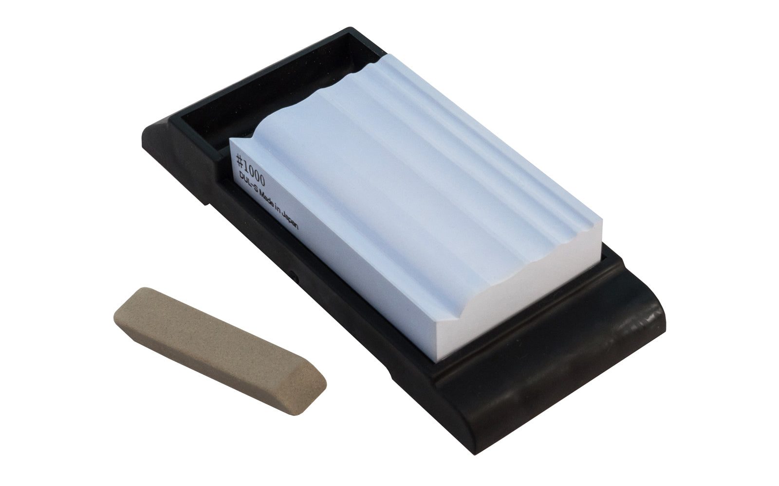 Japanese Suehiro Carving Whetstone 1000 Grit designed to sharpen carving tools & sculpting tools. Stone sharpens rounded blades, triangular blades, flat blades, engraving knives, & various sizes of sculpture knives. Model 2HS-13. 4966684065574. Made in Japan. Includes an eraser for removing grime. Rubberized Base