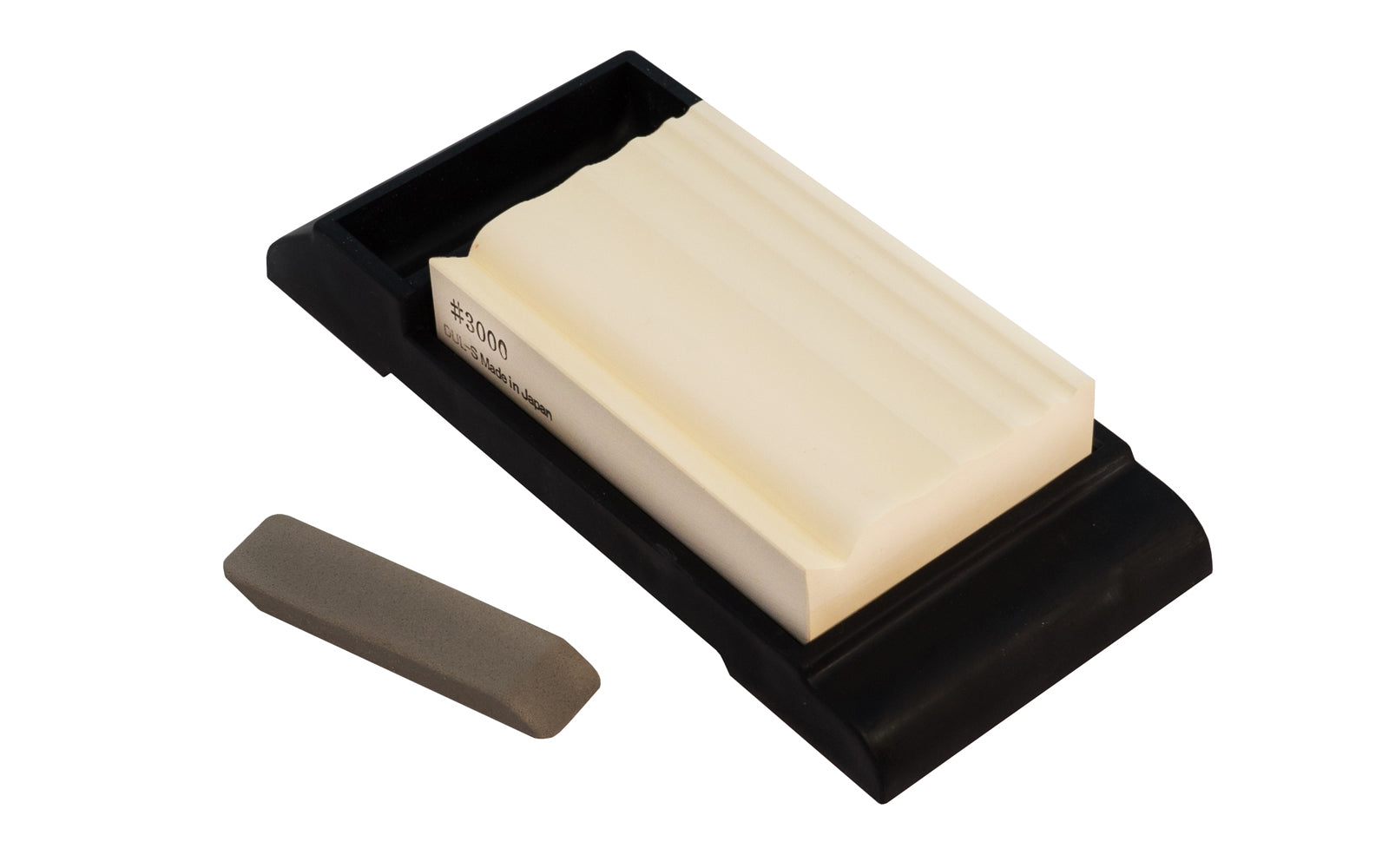 Japanese Suehiro Carving Whetstone 3000 Grit designed to sharpen carving tools & sculpting tools. Stone sharpens rounded blades, triangular blades, flat blades, engraving knives, & various sizes of sculpture knives. Model 2HS-14. 4966684065581. Made in Japan. Includes an eraser for removing grime. Rubberized Base