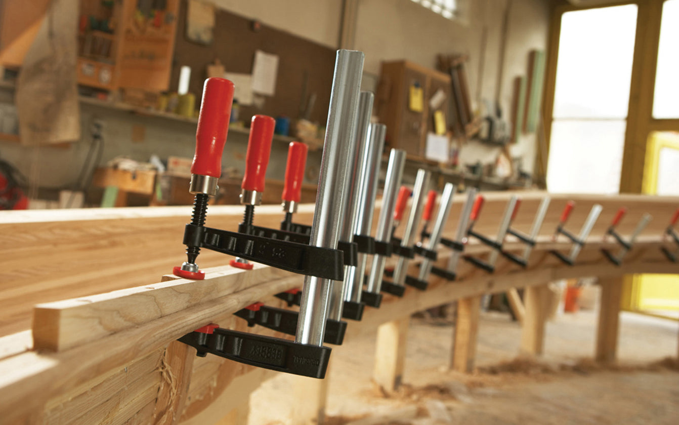 This Bessey 12" Medium-Duty Steel Bar Clamp head is made of malleable cast iron. Fixed jaw & sliding arm generates powerful & rigid clamping. Wooden handles - 1320 lb. clamping pressure - Model TG5.512 - "TG series" Bessey Clamps 12" max opening - 5-1/2" throat depth - Made in Germany - 091162007068. Medium Duty Clamp