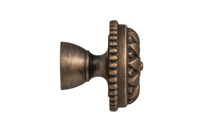 Traditional & classic "French Style" cabinet knob with an elegant flower design & beaded trim. Made of high quality solid brass, his knob has a weighty & durable feel. Great for cabinets, furniture & drawers. The knob is designed in the Late 19th Century style of hardware. Antique brass finish on solid brass material. Available in 1-1/8" diameter & 1-1/2" diameter 