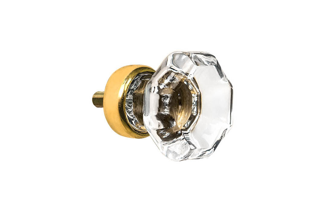 Elegant & classic octagonal cabinet glass knob with attractive genuine clear glass. The glass is carefully set into a handsome solid brass base with a threaded shank in the back. Unlacquered brass base - Will patina naturally over time. Octagon shape knob. 1" Diameter Knob 