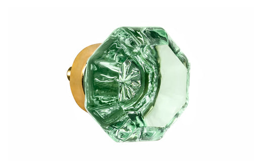 Elegant & classic octagonal cabinet glass knob with an attractive "Depression Green" color. The glass is carefully set into a handsome solid brass base with a threaded shank in the back. Unlacquered brass base - Will patina naturally over time. Octagon shape knob. 1-1/4" Diameter Knob 