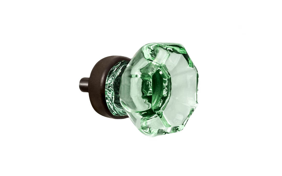 Elegant & classic octagonal cabinet glass knob with an attractive "Depression Green" color. The glass is carefully set into a handsome solid brass base with a threaded shank in the back. Oil rubbed bronze finish on solid brass base. Octagon shape knob. 1" Diameter Knob 